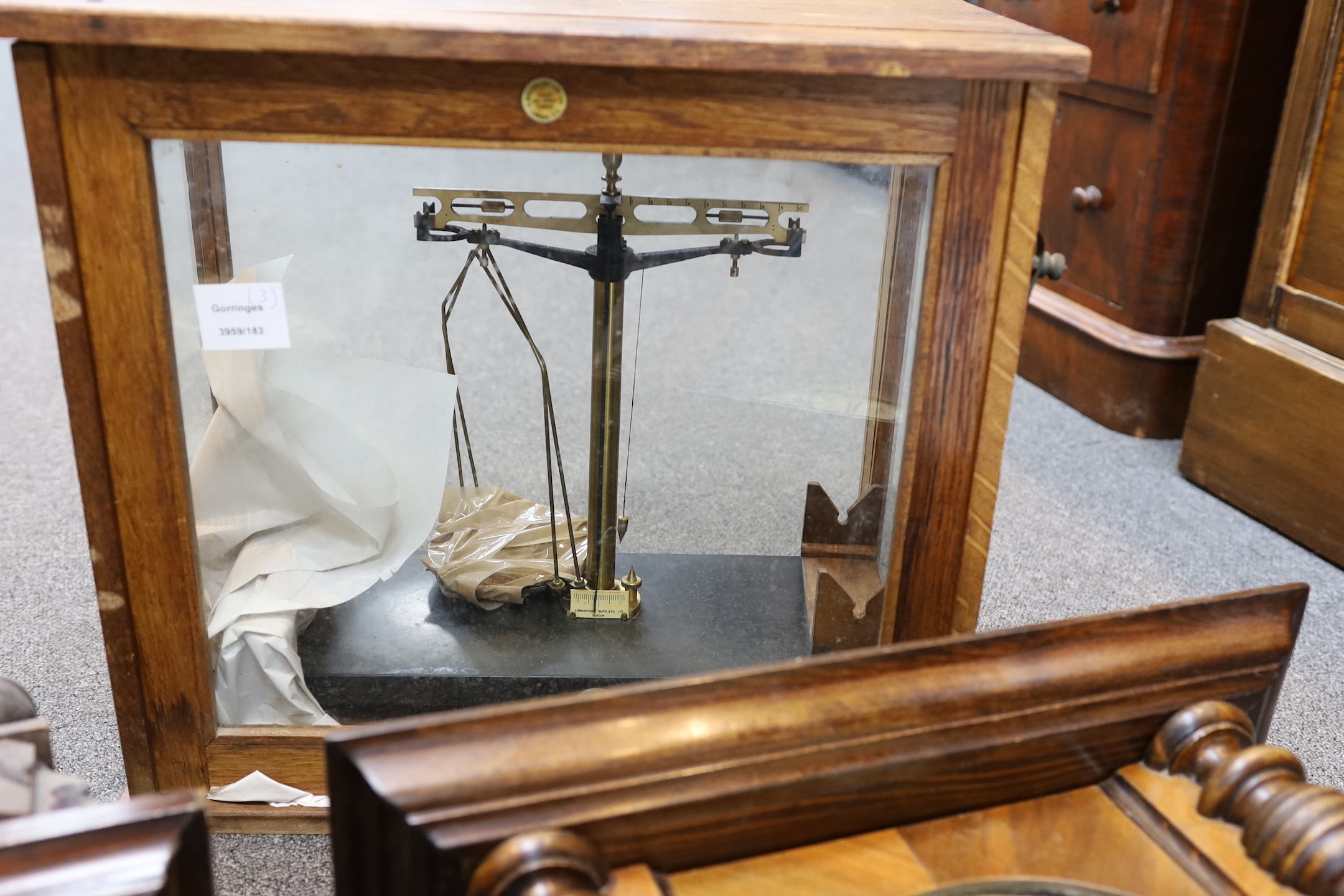 Two late 19th / early 20th century Vienna type wall clocks, larger 119 cms and a set of oak cased scientific beam scales.